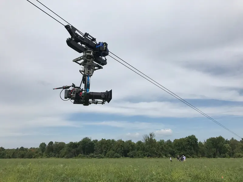 Dactylcam Pro sled with a stabilized head over a field