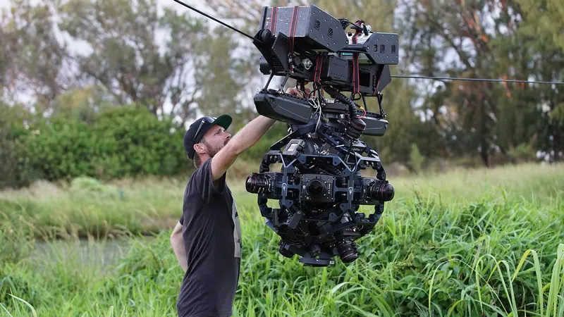 Technician rigging a Dactylcam Pro cable cam with a 360 camera array